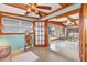 Sitting room with exposed beam ceiling opening to the dining and living areas at 4528 58Th W St, Bradenton, FL 34210