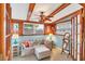 Cozy sitting room featuring wainscoting, exposed beam ceiling, and comfortable seating at 4528 58Th W St, Bradenton, FL 34210