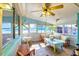 Bright sunroom with tile floors, comfortable seating, and abundant natural light at 4528 58Th W St, Bradenton, FL 34210