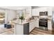Modern kitchen with white cabinets, stainless steel appliances, and granite countertops at 4609 Pleasant Ave, Palm Harbor, FL 34683