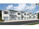 Beautiful townhome exterior featuring light and blue stucco, blue shutters and garage door at 4613 Pleasant Ave, Palm Harbor, FL 34683