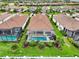 Aerial view of a home featuring a private screened pool, lush landscaping, and a tile roof at 4720 Arpino Ct, Bradenton, FL 34211