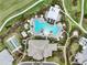 Bird's-eye view of the community's resort-style pool, clubhouse, tennis court, and golf course at 4720 Arpino Ct, Bradenton, FL 34211
