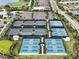 Aerial view showcasing multiple tennis and pickleball courts in a well-maintained community at 4720 Arpino Ct, Bradenton, FL 34211