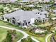 Aerial view of clubhouse with manicured lawns, seating areas, and lush landscaping at 4720 Arpino Ct, Bradenton, FL 34211