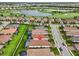 Aerial view of the home with a golf course view and well-manicured lawns in a lovely neighborhood at 4720 Arpino Ct, Bradenton, FL 34211