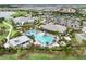 Aerial view of the pool and clubhouse surrounded by lush landscaping and the community at 4720 Arpino Ct, Bradenton, FL 34211