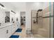 Elegant bathroom with a double sink vanity, glass shower, and spacious walk-in closet at 4720 Arpino Ct, Bradenton, FL 34211