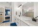 Modern bathroom featuring double sinks, a large mirror, and a glass-enclosed shower at 4720 Arpino Ct, Bradenton, FL 34211