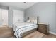 Well-lit bedroom featuring a large bed, dresser, and a double door closet at 4720 Arpino Ct, Bradenton, FL 34211