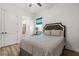 Comfortable bedroom with a full bed, ensuite bath access, and hardwood floors at 4720 Arpino Ct, Bradenton, FL 34211
