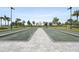 Bocce ball courts with landscaping, seating, and palm tree views at 4720 Arpino Ct, Bradenton, FL 34211
