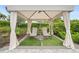 Relaxing cabana with lounge chairs and elegant curtains, perfect for unwinding at 4720 Arpino Ct, Bradenton, FL 34211