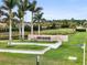 Esplanade at Azario Lakewood Ranch entrance with lush landscaping and serene water features at 4720 Arpino Ct, Bradenton, FL 34211