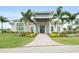 Attractive building entryway with modern architecture, palm trees, and vibrant landscaping at 4720 Arpino Ct, Bradenton, FL 34211