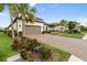 Attractive single-Gathering home with a brick driveway and a well-manicured front yard with palm trees at 4720 Arpino Ct, Bradenton, FL 34211