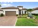 Charming single-Gathering home with a brown tile roof, manicured lawn, and a two-car garage at 4720 Arpino Ct, Bradenton, FL 34211