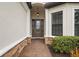 Close-up of the front door with sidelights, brick accents, and an elegant overhead light fixture at 4720 Arpino Ct, Bradenton, FL 34211
