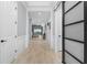 Bright hallway features light wood floors, gray walls and a view into the home's Gathering room at 4720 Arpino Ct, Bradenton, FL 34211