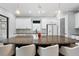 Bright kitchen features granite countertops, stainless steel appliances, a large island, and sleek white cabinetry at 4720 Arpino Ct, Bradenton, FL 34211
