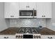 Modern kitchen features stainless steel appliances, granite countertops, white cabinets, and a gas cooktop at 4720 Arpino Ct, Bradenton, FL 34211