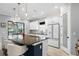 Modern kitchen features a large island with granite countertops, white cabinets, and stainless steel appliances at 4720 Arpino Ct, Bradenton, FL 34211