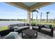 Covered outdoor patio with comfortable seating and scenic water views at 4720 Arpino Ct, Bradenton, FL 34211