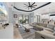 Stylish living room with light hardwood floors, modern furniture, and a sliding glass door to the outdoor space at 4720 Arpino Ct, Bradenton, FL 34211