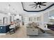 Bright open-concept living area, featuring a large kitchen island with seating and a modern sectional couch at 4720 Arpino Ct, Bradenton, FL 34211