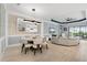 Inviting living room area with an accent wall and modern lighting which opens up to the kitchen space at 4720 Arpino Ct, Bradenton, FL 34211