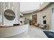 Bright spa lobby featuring stylish curved reception desk and comfortable seating area with built-in shelving at 4720 Arpino Ct, Bradenton, FL 34211