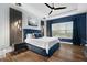 Sophisticated primary bedroom featuring a plush bed, accent wall, and ample natural light at 4720 Arpino Ct, Bradenton, FL 34211