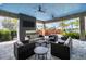 Stylish outdoor lounge area with comfortable seating, a fireplace, and a view of lush landscaping at 4720 Arpino Ct, Bradenton, FL 34211