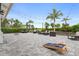 Outdoor patio area with comfortable seating, string lights, and lush landscaping at 4720 Arpino Ct, Bradenton, FL 34211