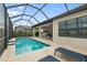 Inviting screened-in pool with travertine deck, seamlessly connecting indoor and outdoor living spaces at 4720 Arpino Ct, Bradenton, FL 34211