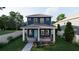 Charming two-story home with a covered front porch and beautiful landscaping at 4755 11Th S Ave, St Petersburg, FL 33711