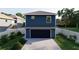 Rear elevation of a two-story home with a convenient built-in garage and driveway at 4755 11Th S Ave, St Petersburg, FL 33711
