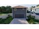 Rear view of the house featuring a two-car garage and a well-maintained, fenced backyard at 4759 11Th S Ave, St Petersburg, FL 33711
