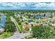 Aerial view showcases a charming home in a well-developed neighborhood with nearby lakes and lush greenery at 4811 14Th E Ave, Bradenton, FL 34208