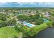 Aerial view of community amenities including neighborhood pool, tennis courts, and water views at 4811 14Th E Ave, Bradenton, FL 34208