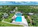 Aerial view of a community pool area including a playground, plenty of seating, and beautiful landscaping at 4811 14Th E Ave, Bradenton, FL 34208