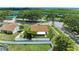 Aerial view of property with fenced yard and surrounding neighborhood, and water views in the distance at 4811 14Th E Ave, Bradenton, FL 34208