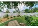 Backyard with white fence, landscaping, grass, and paver path at 4811 14Th E Ave, Bradenton, FL 34208