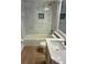 Bathroom showcasing updated marble tile in shower and countertop with light wood cabinets at 4811 14Th E Ave, Bradenton, FL 34208