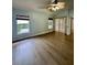 Bright bedroom featuring light walls, wood floors, a ceiling fan, windows, and glass patio door at 4811 14Th E Ave, Bradenton, FL 34208