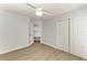 This bedroom features a ceiling fan, light gray walls, wood-look floors and a closet at 4811 14Th E Ave, Bradenton, FL 34208
