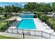 Aerial shot of a pristine community pool surrounded by seating, offering a relaxing escape for residents at 4811 14Th E Ave, Bradenton, FL 34208