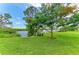 Scenic waterfront park with lush lawn, mature trees, and tranquil seating areas, offering a serene outdoor escape at 4811 14Th E Ave, Bradenton, FL 34208