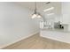 Dining area with modern lighting, light floors, and neutral walls open to the kitchen area at 4811 14Th E Ave, Bradenton, FL 34208