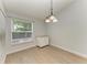 Bright dining area with wood-look floors, a window with a view, and modern lighting at 4811 14Th E Ave, Bradenton, FL 34208